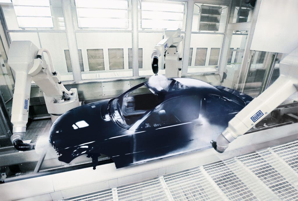A black car is powder painted with the help of DUERR technologies